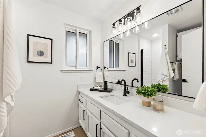 A well-sized fourth bedroom with LVP flooring, a large window with treetop views, and a neutral finish ready for any use.