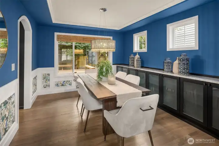 Large formal dining room with beautiful hardwoods, updated lighting, built-ins, and overlooking your private backyard.