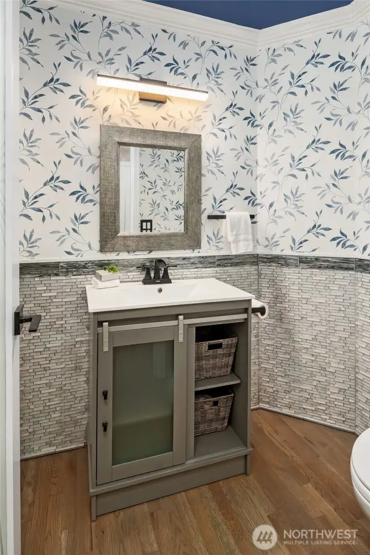 Powder room on main with new vanity and floors.