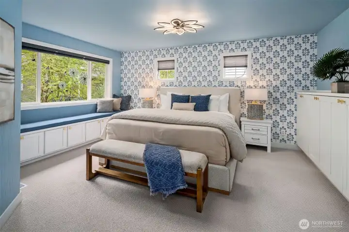 Primary bedroom with window seat and custom built-ins.