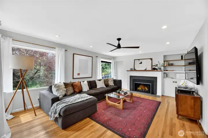 The spacious living room with gas fireplace and access to the entertainment sized deck