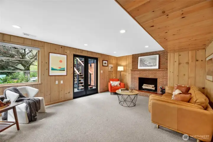 The lower level family room with wood burning fireplace also has easy access to the backyard