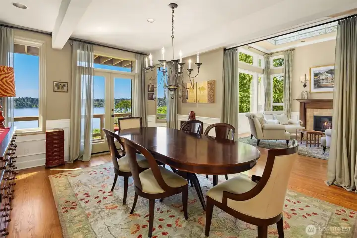 Elegant dining room with Lake Washington views, opening to a view deck and seamlessly connected to the light-filled living spaces.