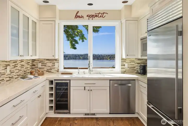 Chef’s kitchen with lakeview sink, custom cabinetry, and a seamless connection to indoor-outdoor living.