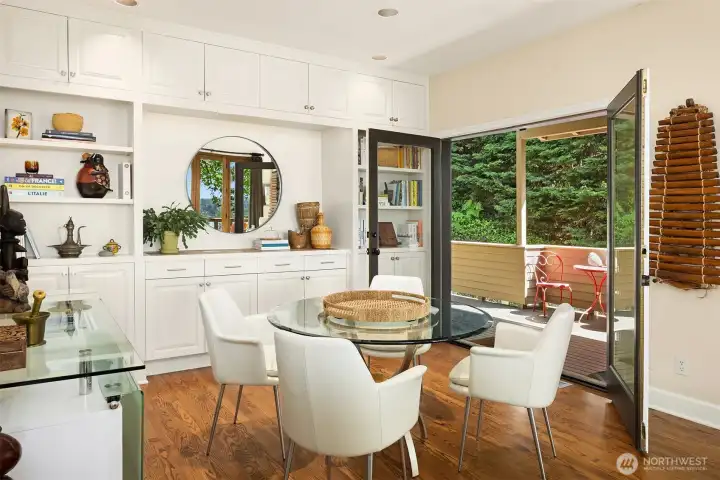 Charming breakfast nook with built-ins and direct access to a private balcony—perfect for morning coffee surrounded by lush greenery.