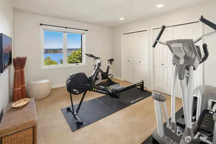 Lower level bedroom with calming lake views—private, bright, and generously sized. Designed to flex with your needs, easily accommodating a home gym, office, or creative space.