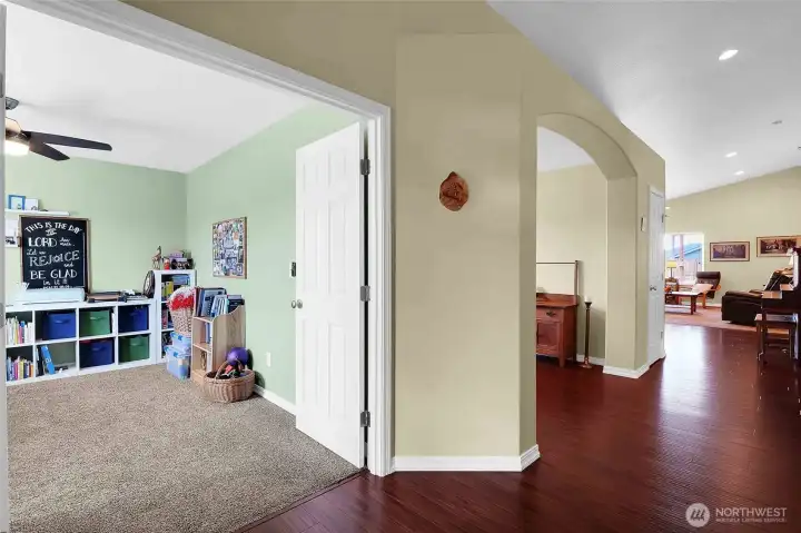 The bonus room off the entry, with French doors, can be used as a craft room or bedroom, has a closet, and faces the front of the house.