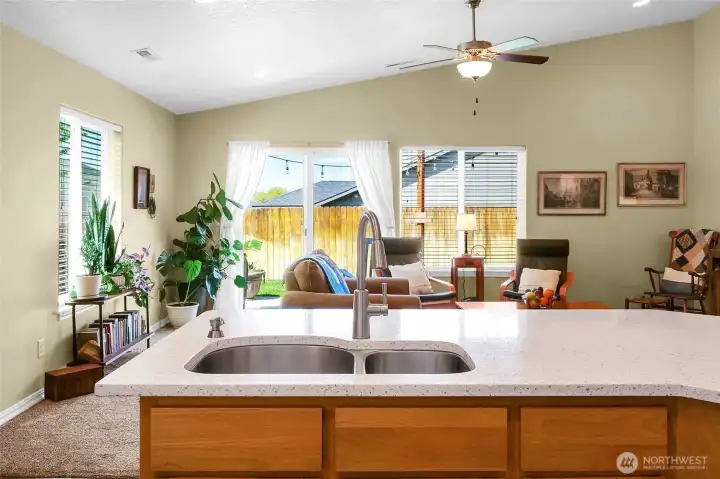 You'll love all the natural light coming into the living room and kitchen as it shines off the quartz countertops!