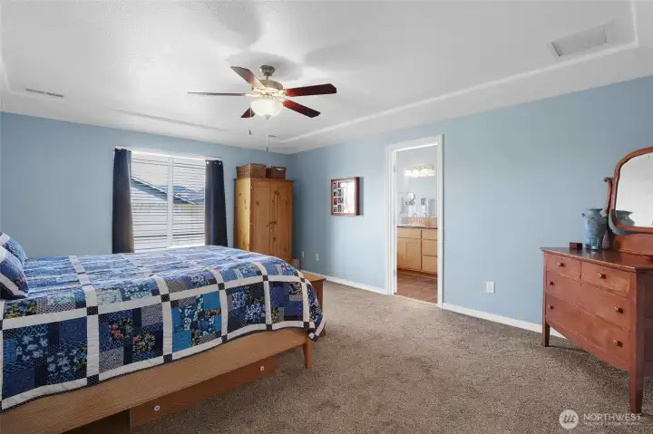 As you step into the primary bedroom, the first thing you'll notice is how much natural light and space there is!