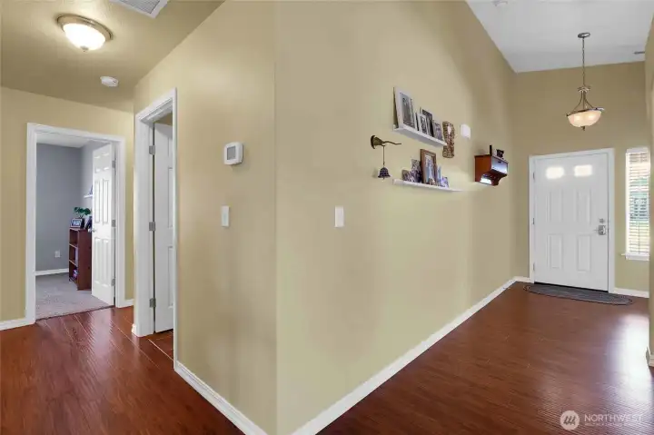From the front door, turn right into this hall to access the laundry room and third bedroom.
