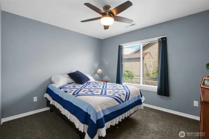 Third bedroom, which also has a ceiling fan, is on the right side of the home. Window treatments (faux wood blinds and curtains) are a part of the transaction.