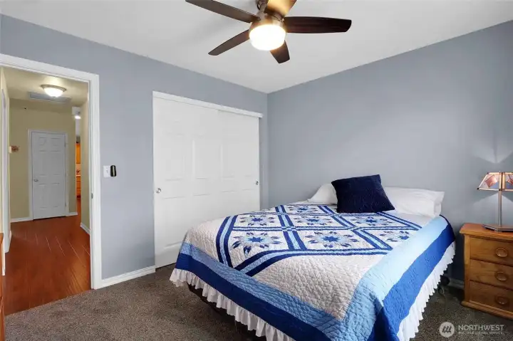 Another view of the third bedroom and hallway to the garage and out to the kitchen.