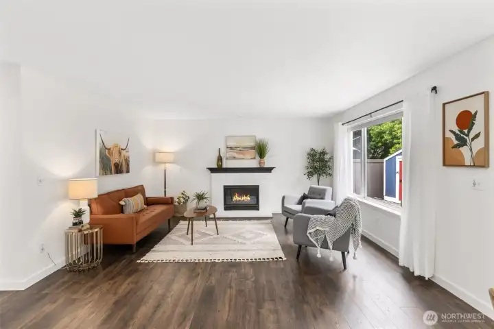 Inviting great room featuring a cozy gas fireplace and easy access to the covered patio, creating the perfect indoor-outdoor flow for relaxing or entertaining year-round.
