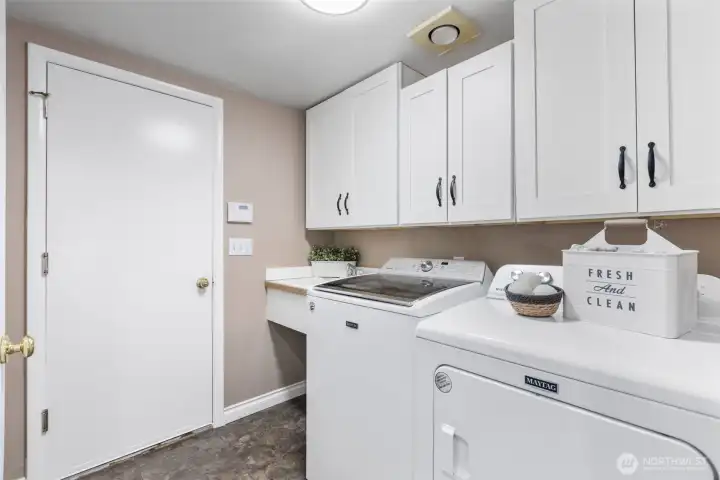 Utility room off the garage. Washer and dryer stay with the home.