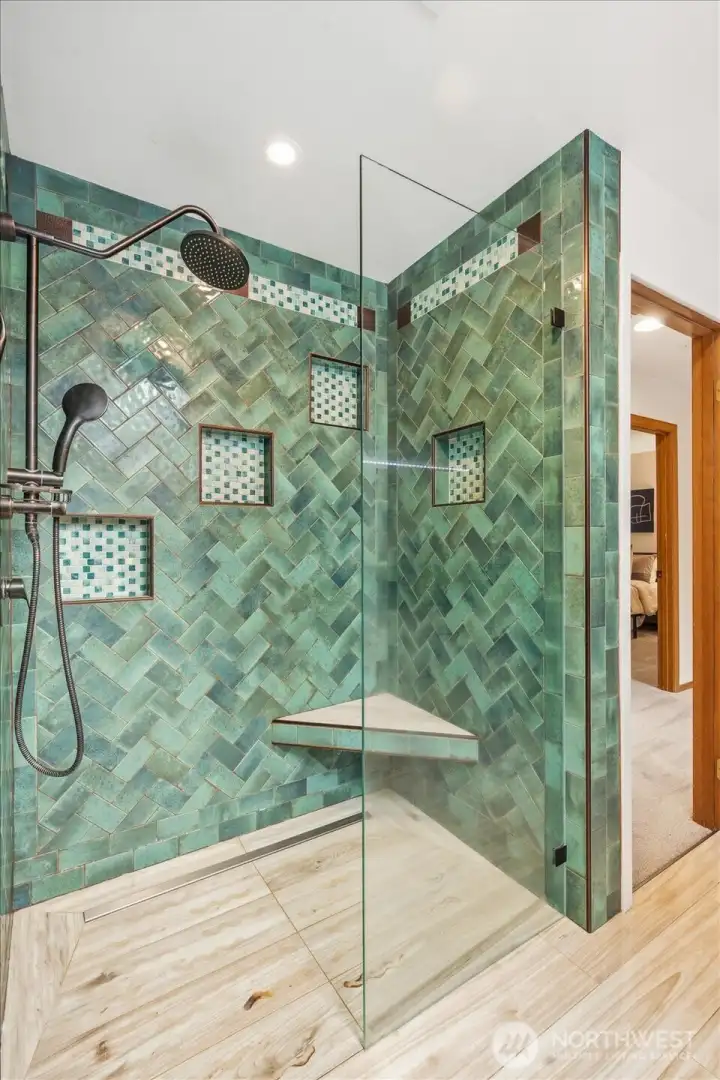 The upstairs bathroom sports an elegant shower with heated floors The upstairs bathroom sports an elegant shower with heated floors