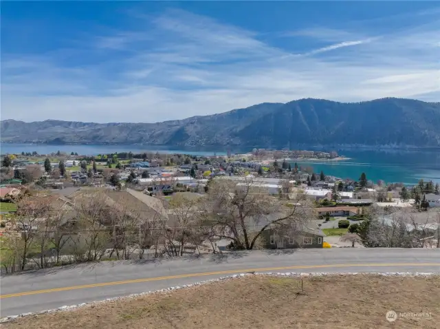 View 1 of homesite looking across road towards views of Lake Chelan and the surrounding mountains.