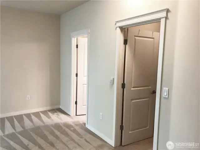 Primary bedroom features French doors, walk-in closet, and ensuite full bathroom.