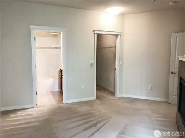 Another view of the primary bedroom - bathroom on left, walk-in closet on right.