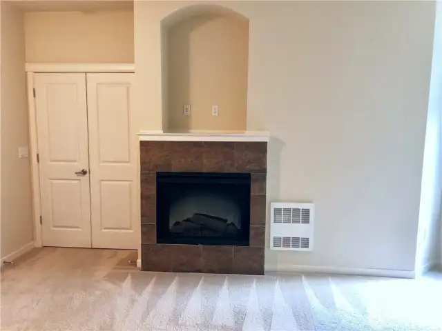 Primary bedroom looking towards French doors and gas fireplace.