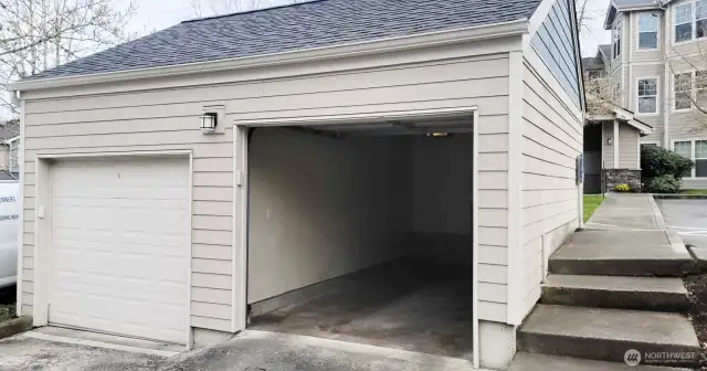 Garage with automatic opener. Stairs to the right lead to the BBQ/picnic area and mailboxes.