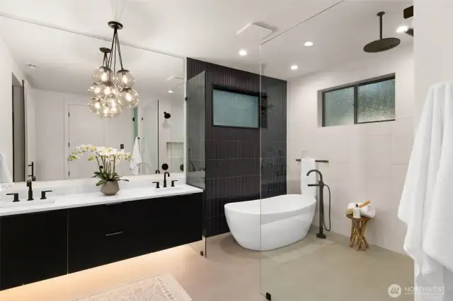 Spa-inspired primary bathroom with walk-in     customized closet