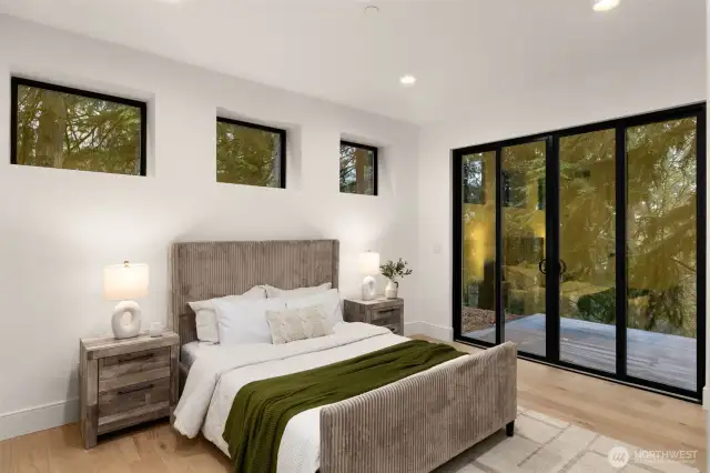 Lower level guest bedroom that opens to the patio and backyard