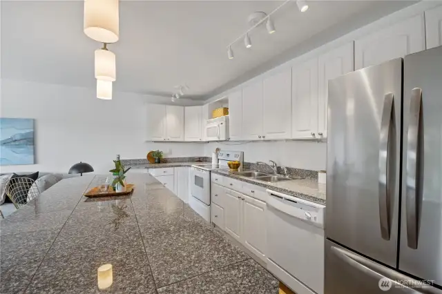 Granite countertops anchor the kitchen with elegance and durability, providing the perfect foundation for your next culinary creation.