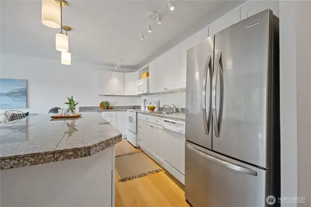 A sleek stainless steel refrigerator, along with matching appliances, enhances both the style and function of the kitchen—keeping your ingredients fresh and your space looking polished.