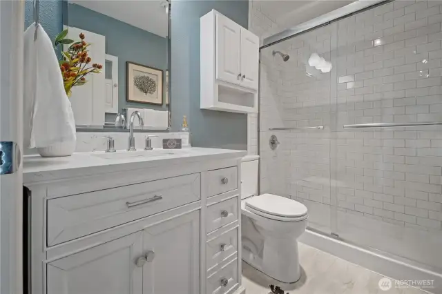 The freshly updated bathroom features classic subway tile, a sleek modern vanity, and stylish finishes—bringing a clean, contemporary feel to your daily routine.