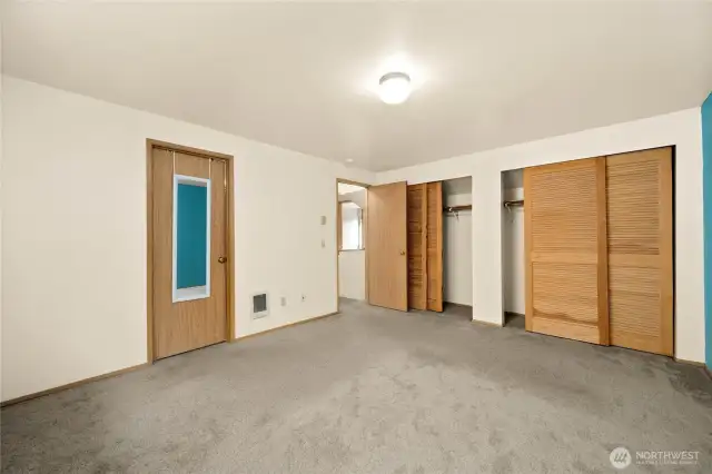 The master bedroom with access to the full bath through the door on the left.  Two large full-sized closets with beautiful wood doors.
