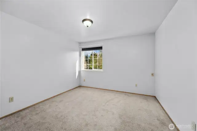 The third bedroom upstairs has a window overlooking the neighborhood.