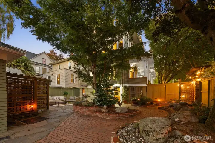 Fully landscaped lush spa like backyard with sauna that conveys with sale