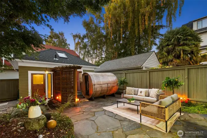 Fully landscaped lush spa like backyard with sauna that conveys with sale