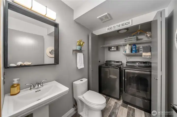 Guest bath located off the entrance with washer and dryer.