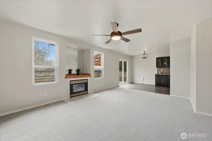 Living room has new carpeting & paint, double windows and gas fireplace