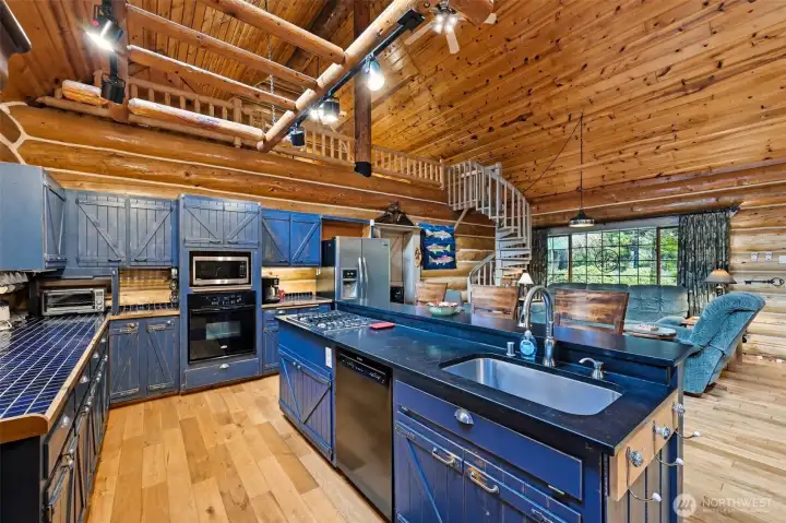Kitchen with gas cooktop, electric oven, dishwasher and gourmet prep station