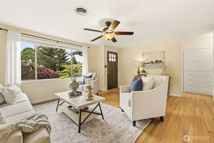 Bright living room filled with natural light and peaceful garden views.