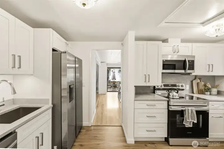 Updated kitchen features modern finishes, abundant storage, and functional workspace.