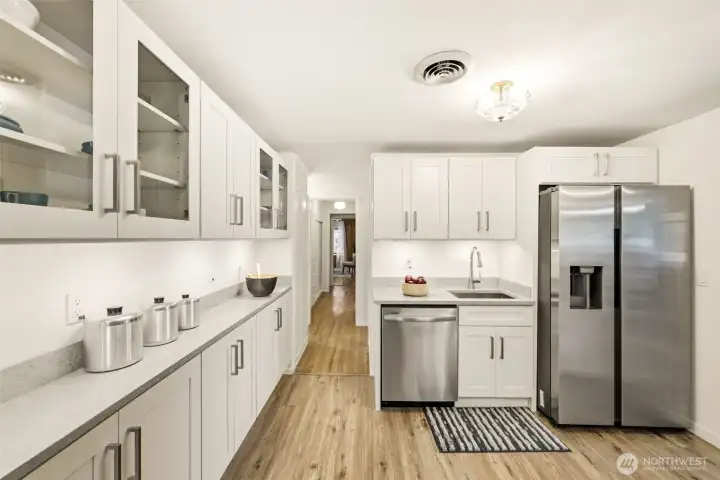 Kitchen includes newer stainless steel appliances and contemporary updates.