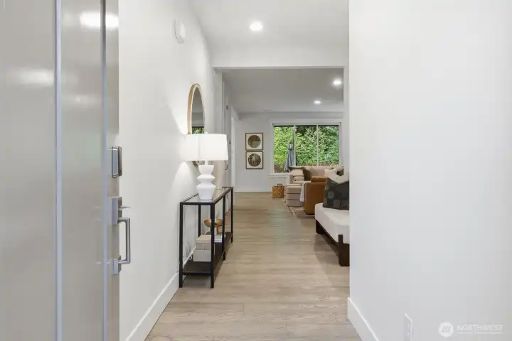 A welcoming entry sets the tone with clean modern lines and seamless sightlines into the main living spaces.
