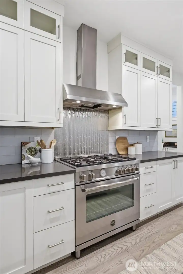 A high-performance Bertazzoni gas range is paired with premium KitchenAid appliances.
