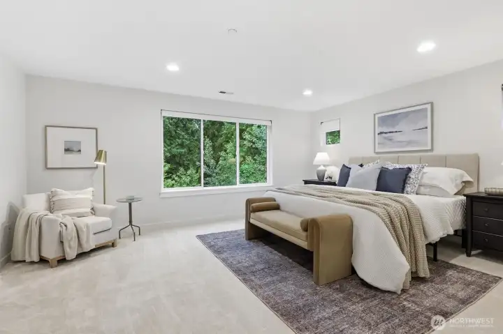 The generous upstairs primary suite overlooks the protected greenbelt, offering a peaceful escape.