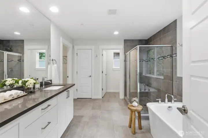 Dual vanities, expansive proportions, and refined finishes create a bright spa-inspired ensuite retreat.