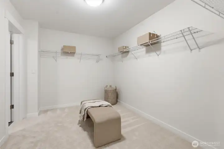 Expansive walk-in closet connects directly to the laundry room for seamless everyday convenience.