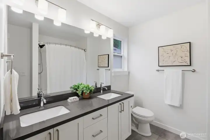 Full upstairs guest bath with generous linen storage adds everyday convenience.