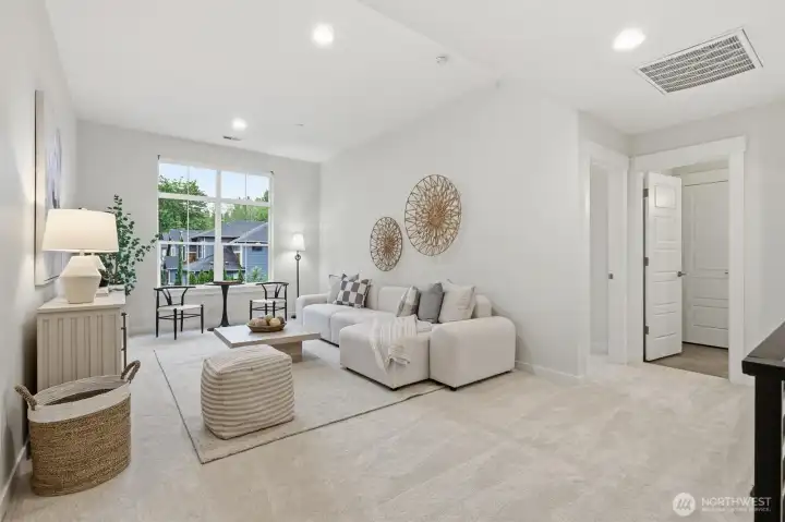 The vaulted loft creates an ideal secondary living space for movie nights, play, or relaxed everyday lounging.