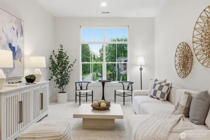 Oversized windows bring beautiful natural light into the airy upper-level loft.