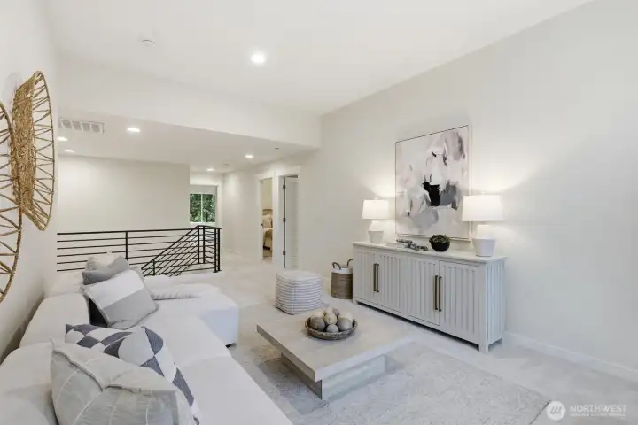 The open-concept loft adds spaciousness and connection throughout the upper level.