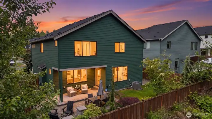Twilight evenings showcase the home’s rare blend of privacy, outdoor living, and warm modern design, all tucked against a serene greenbelt backdrop.