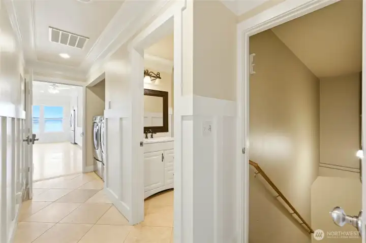 Mudroom enters to this hallway; downstairs, guest bath and laundry, into main floor of home.